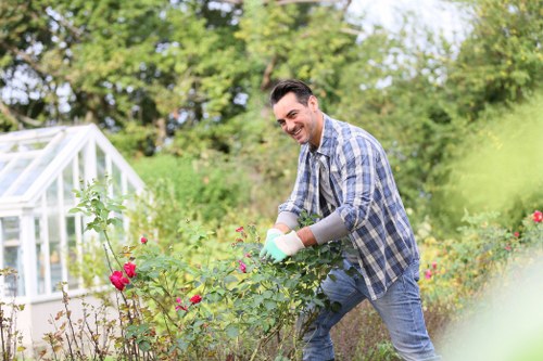 Community gardener tending raised beds in New Cross community garden